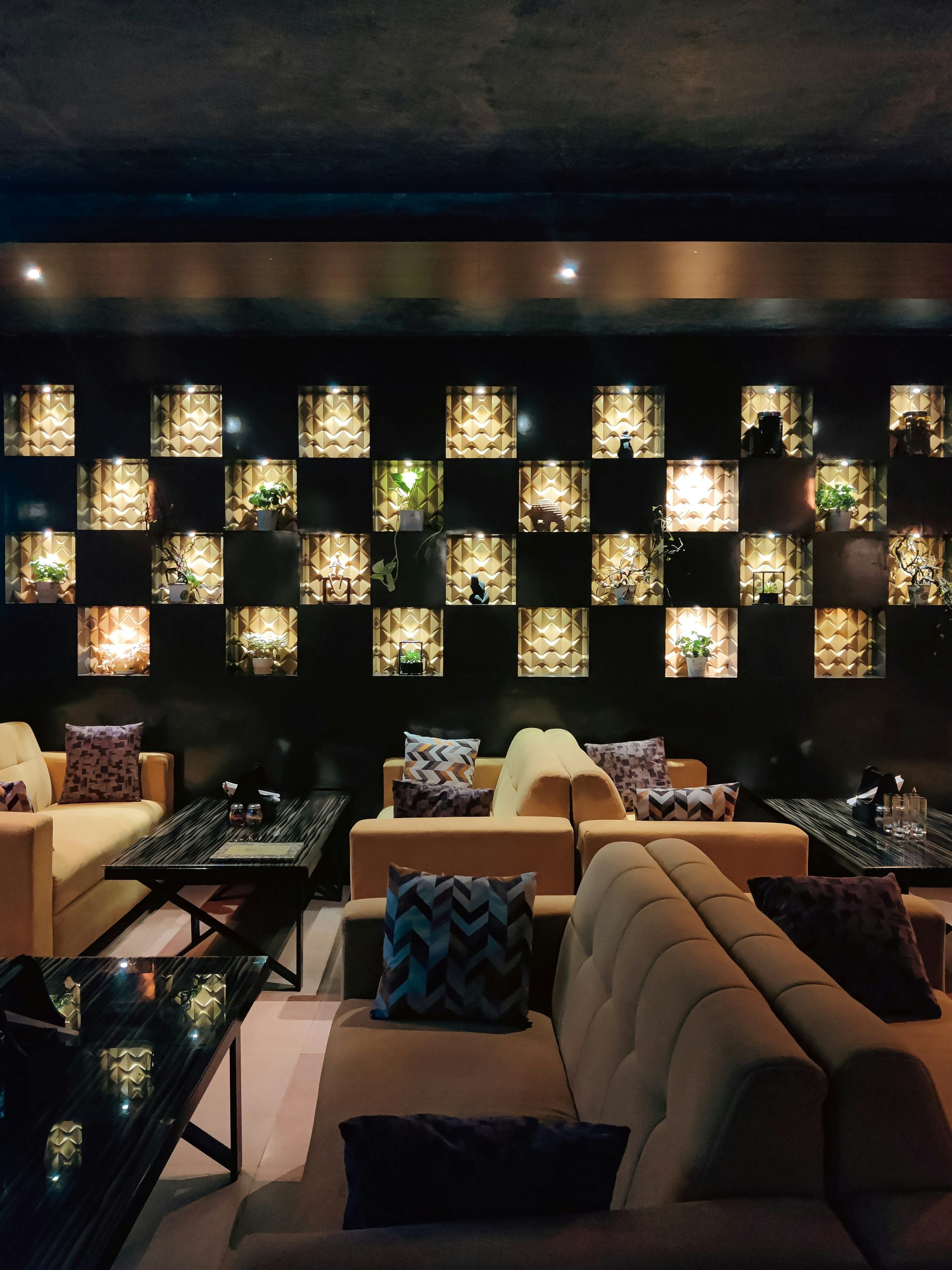 a room with couches, tables and lamps